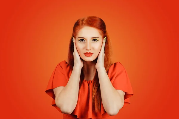 Redhead young woman covering ears looking at camera — Stock Photo, Image