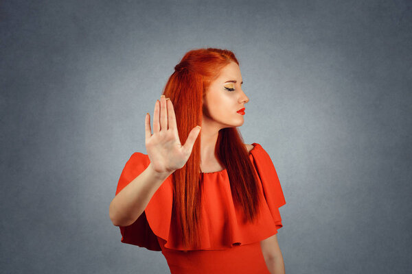 Redhead woman showing Stop gesture with hand
