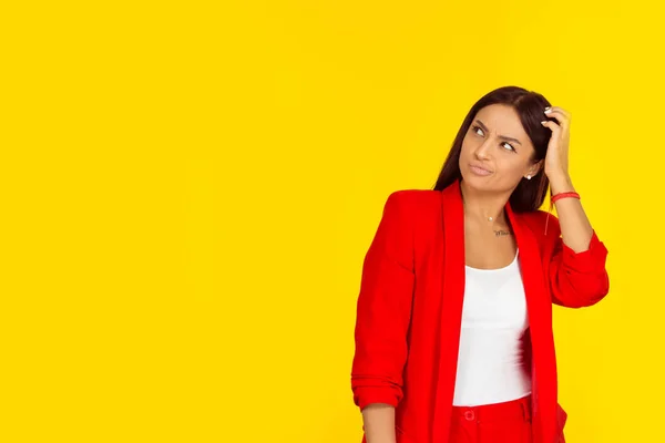 Portrait closeup funny confused skeptical woman girl female thinking with memory loss looking up isolated on yellow background with copy space. Horizontal image. Multicultural girl, Natural, no makeup