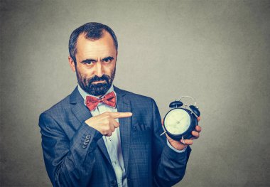 man holding alarm clock and pointed it out clipart