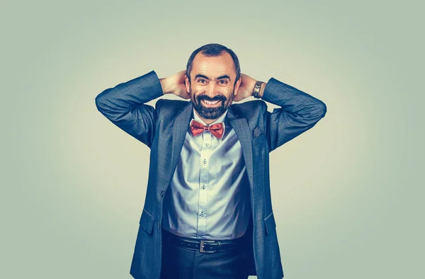 Man keeping hands behind his head looking surprised — ストック写真