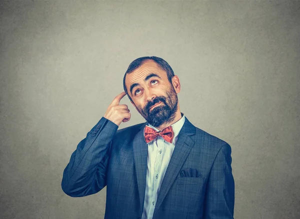 man scratching head, thinking deeply about something, looking up