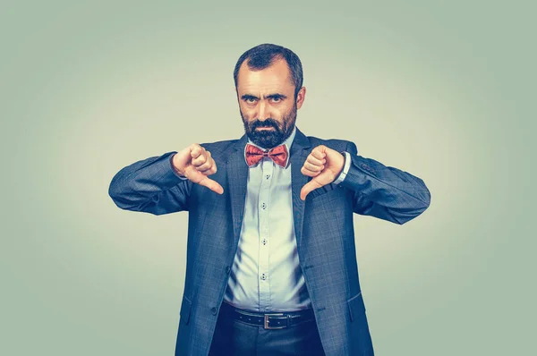 Angry, unhappy, young man showing thumbs down sign — 스톡 사진