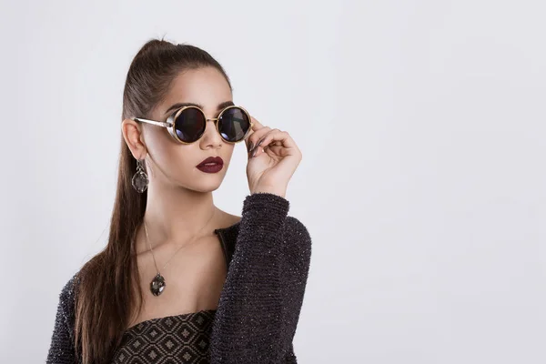 Closeup portrait confident successful beautiful attractive young woman fashion girl posing holding sunglasses hand on glasses isolated white grey background wall Positive human emotion face expression — Stock Photo, Image