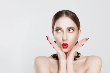 wow. Woman concerned confused skeptical excited thinking planning looking to the side hands on cheeks, isolated white grey wall. Human face expression emotion body language. Shocked surprised stunned