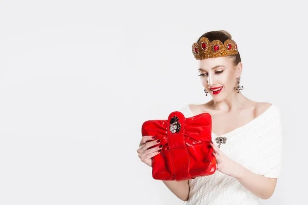 Smiling business womPortrait of young smiling crowned beauty queen woman holding bag wallet happy looking into it, having moneyan holding pointing at many credit cards in — Stock Photo, Image