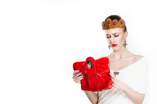 Portrait of young unhappy poor crowned beauty queen frustrated woman holding looking in her bag wallet happy looking into it, not having money — 스톡 사진