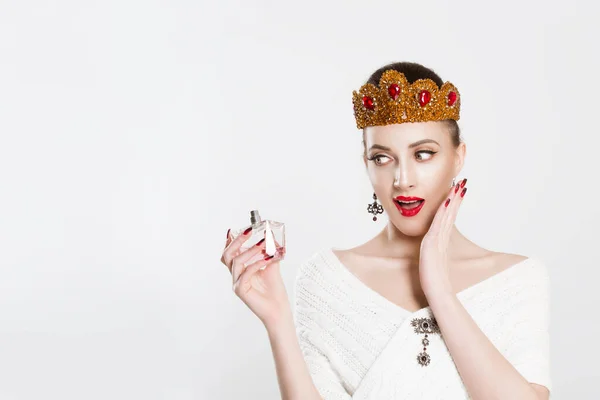 Wow, amazing my favorite perfume it's on sale. Surprised woman beauty queen crowned girl looking at a new perfume fragrance excited isolated white background wall — 스톡 사진