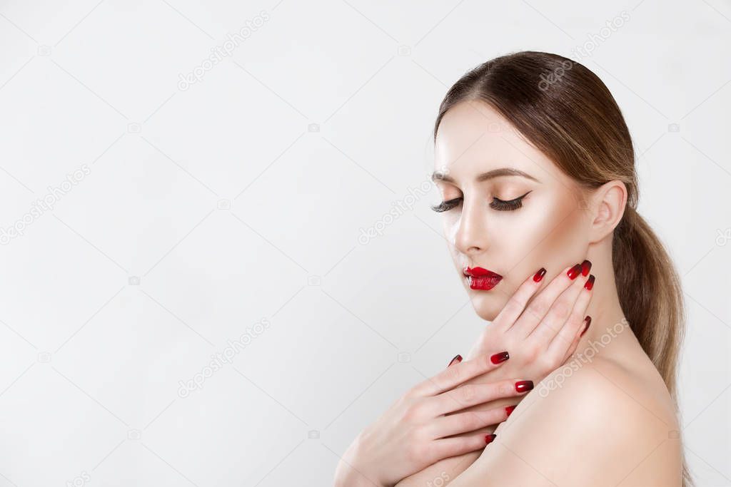 Sexy Beauty Girl with black eyelashes Red Lips and Nails. Provocative natural Make up. Luxury Woman with Eyes Closed in profile hands on face. Fashion Brunette Portrait isolated white grey background 