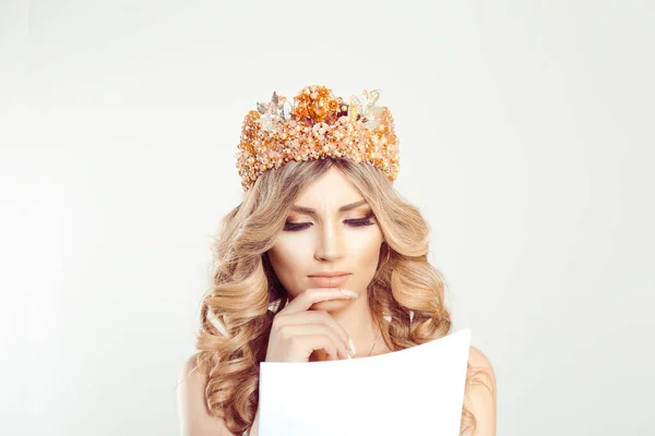 New contract concept. Worried Beauty queen girl woman actress miss looking skeptical analyzing papers newspaper statement documents isolated white background wall. Full makeup clean skin crystal crown