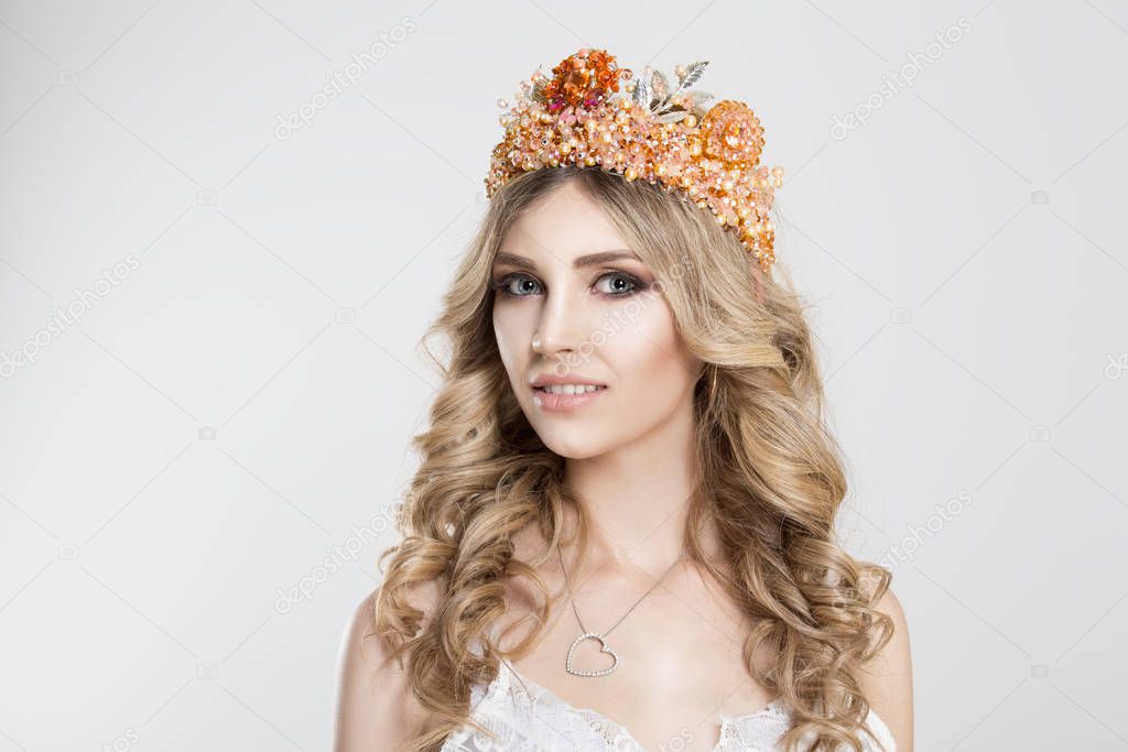 Beauty crowned queen girl woman actress miss bride looking at you camera interested pensive isolated white background. Full makeup diamond silver pink crystals crown pastel colors curly blonde hair