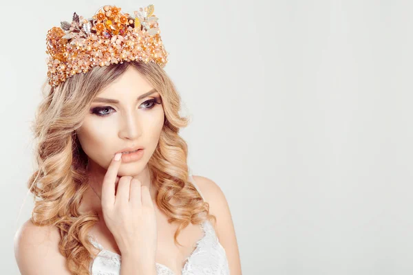 Sad thoughtful beauty woman. Closeup pensive thinking woman looking down with white gold diamond crown on head, curly long blonde hair isolated white gray background — 스톡 사진