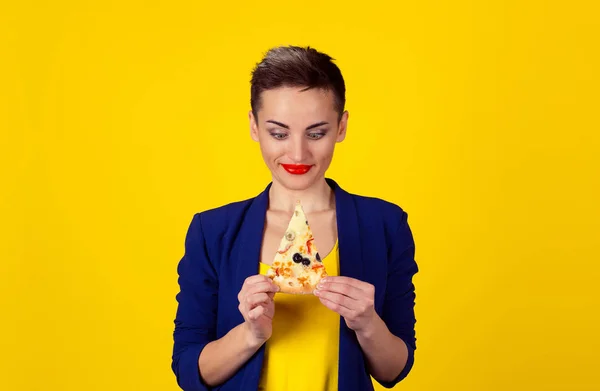 Fast fat food love. Closeup portrait young eager greedy confused woman holding looking at fatty pizza craving junk food trying to resist temptation to eat isolated yellow background. Face expression — Stock Photo, Image