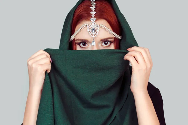 Beautiful Arabian style girl portrait. Portrait of beauty Indian model with bright make-up who is hiding, cover her face behind the green veil hijab scarf. — 스톡 사진