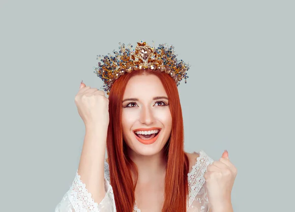 Happy beauty queen woman exults pumping fists ecstatic celebrates success pretty woman winner looking up happy with crystal crown on head isolated on light gray