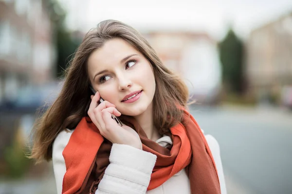 Phone talk. Portrait of business woman on cellphone cheerful  isolated in de focused city Brussels Belgium on background