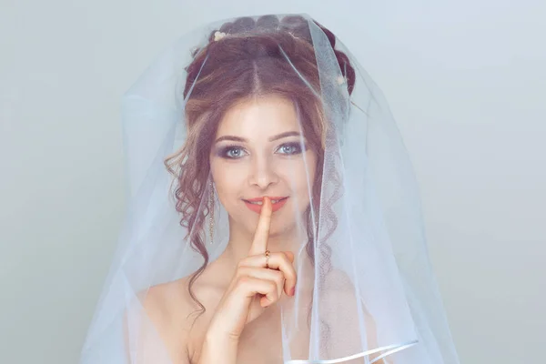 Bride shh woman wide eyed asking for silence secrecy with finger on lips hush hand gesture white