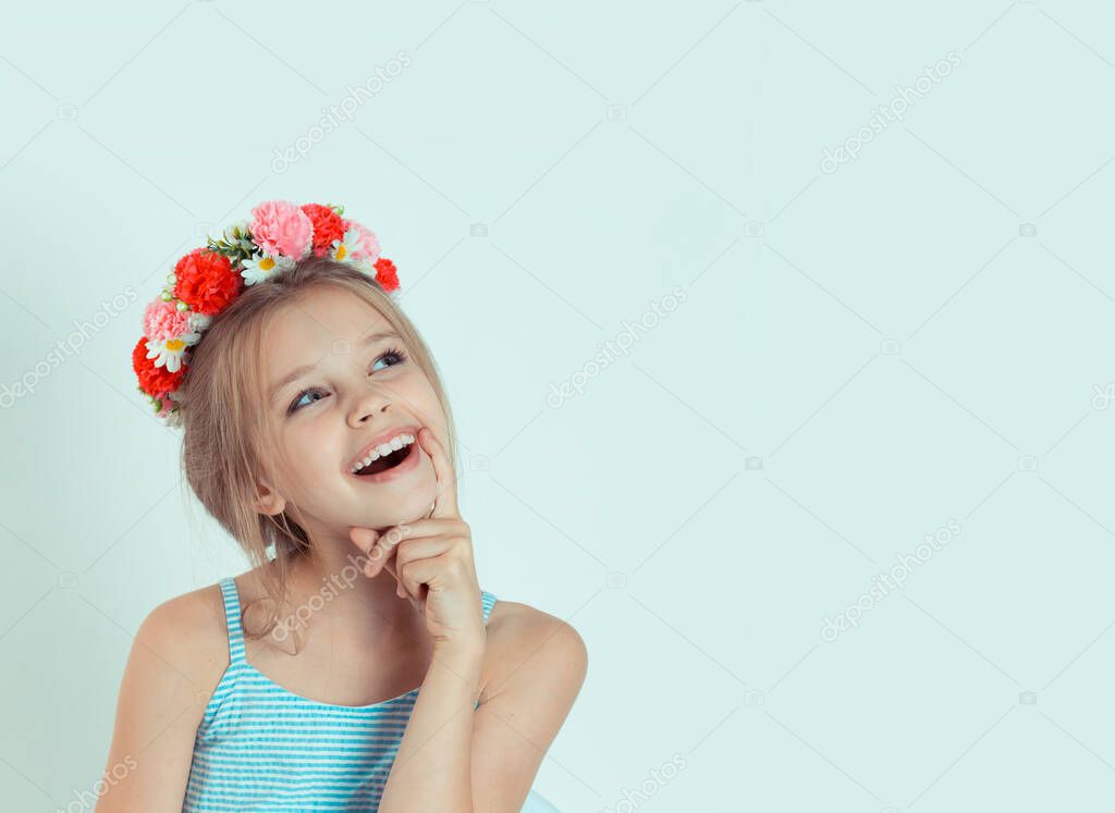 Closeup portrait little Girl thinking daydreaming having idea hand on chin. Closeup portrait of Caucasian kid model with floral headband isolated on white green gray copy space background.