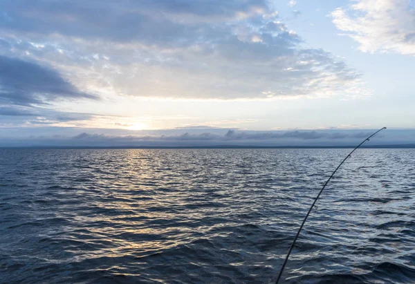 Fisherman's spinning rod in the sun set — Stock Photo, Image
