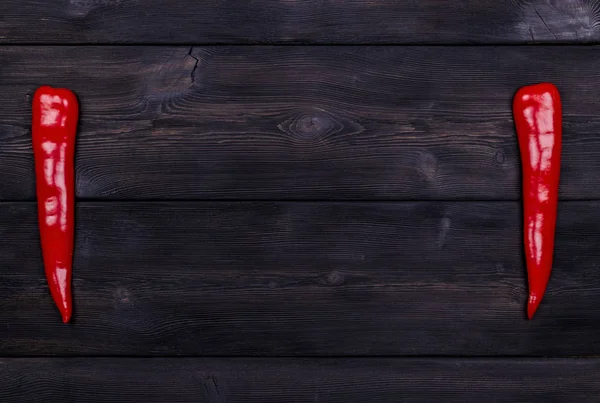 Rote Chilischote auf dem Hintergrund der dunklen Holzstruktur — Stockfoto
