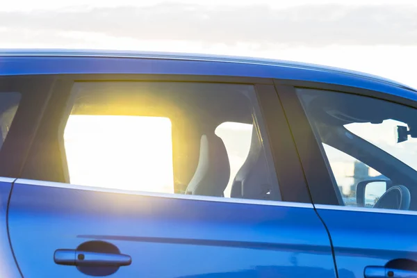 Захід сонця через вікно сучасного автомобіля, зовнішні деталі автомобіля — стокове фото