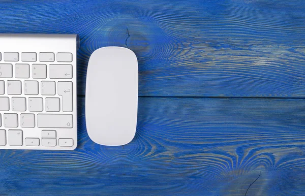 Lugar de trabajo de negocios con ordenador, teclado inalámbrico y ratón sobre fondo de mesa de madera azul viejo. Escritorio de oficina con espacio de copia — Foto de Stock