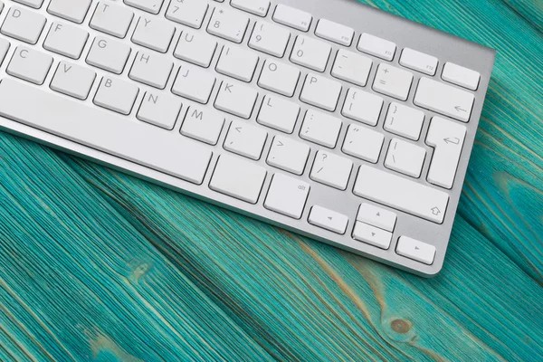 Lugar de trabajo de negocios con teclado inalámbrico sobre fondo de mesa de madera azul antiguo. Escritorio de oficina con espacio de copia — Foto de Stock