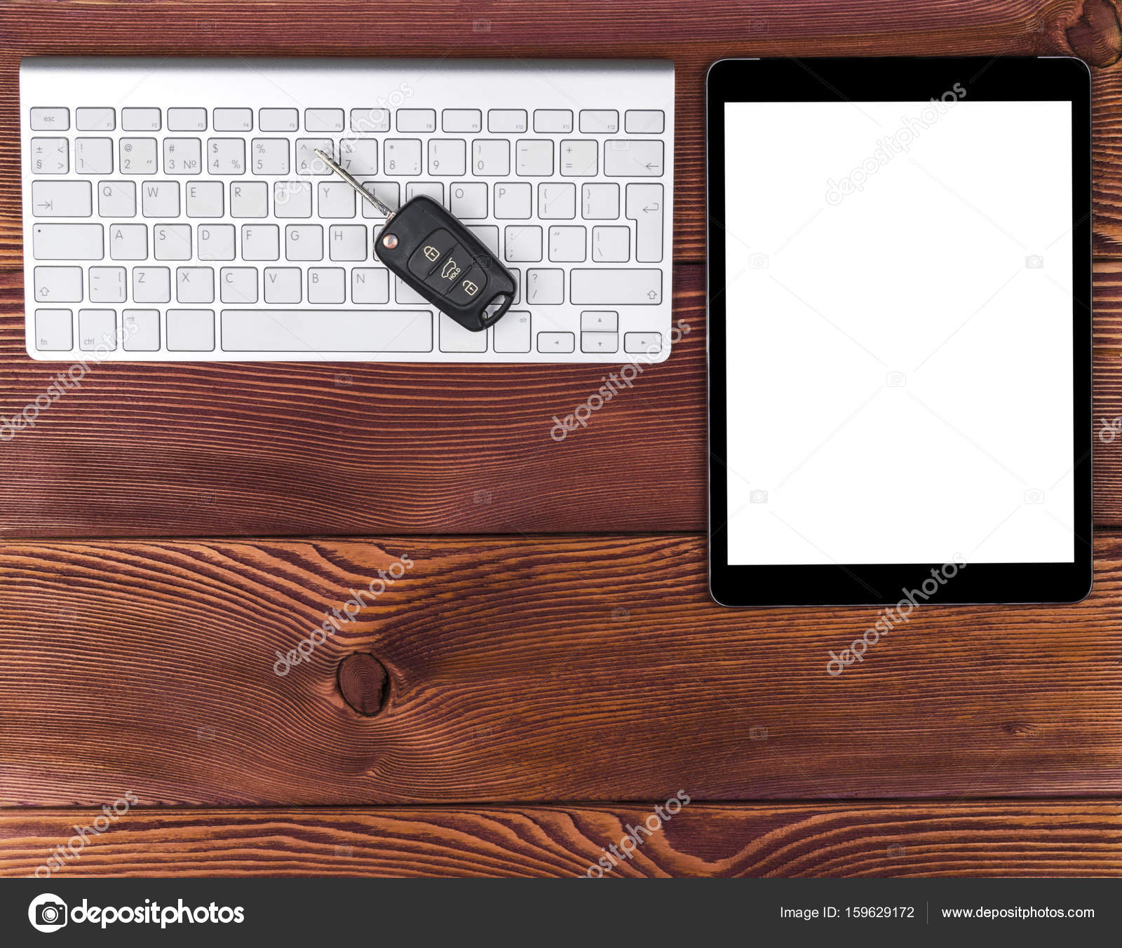 Business Workplace With Wireless Keyboard Tablet Computer And Car Business Workplace With Wireless Keyboard Tablet Computer And Car Keys On Red Wooden Background Office Desk Copy Space Empty For Text Photo