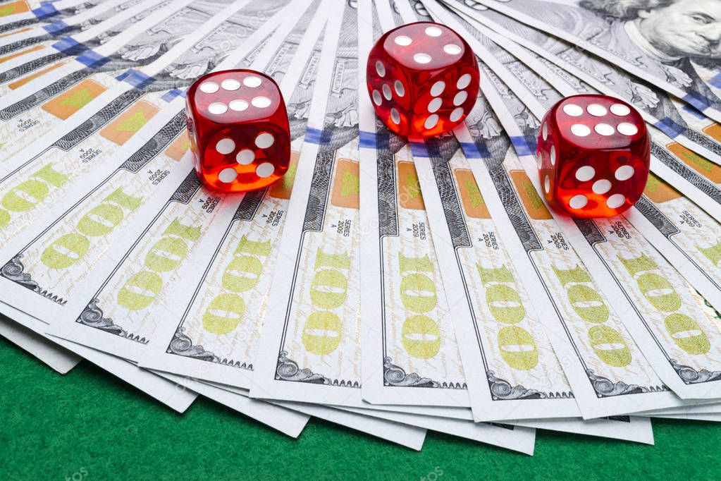 Poker dice rolls on a dollar bills, Money. Poker table at the casino. Poker game concept. Playing a game with dice. Casino dice rolls. Concept for business risk. chance good luck