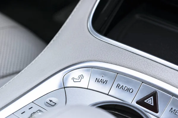 Media and navigation control buttons of a Modern car. Car interior details. White leather interior of the luxury modern car. — Stock Photo, Image