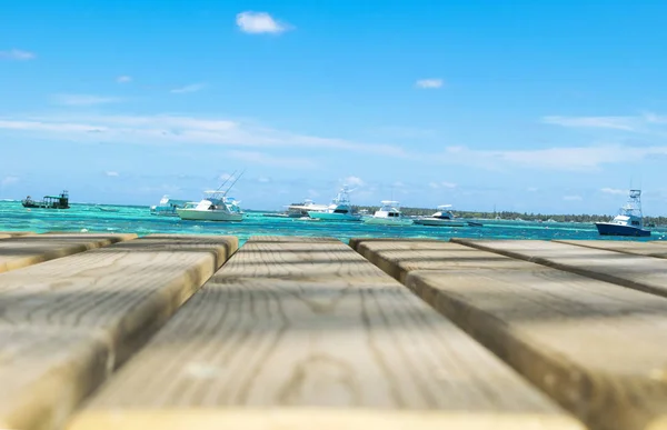 Wooden board empty table in front of blue sea, yachts & sky background. Perspective wood floor over sea, yachts and sky  beach & summer concepts. — Stock Photo, Image