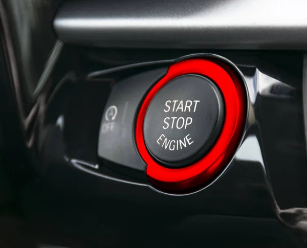 Car dashboard with focus on red engine start stop button, car interior details — Stock Photo, Image