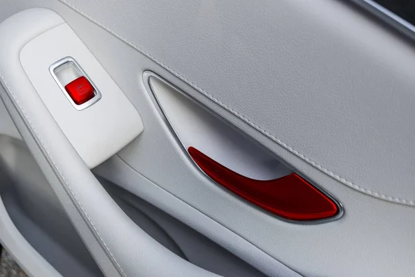 Car white leather interior details of door handle with windows controls and adjustments. Car window controls of modern car. — Stock Photo, Image