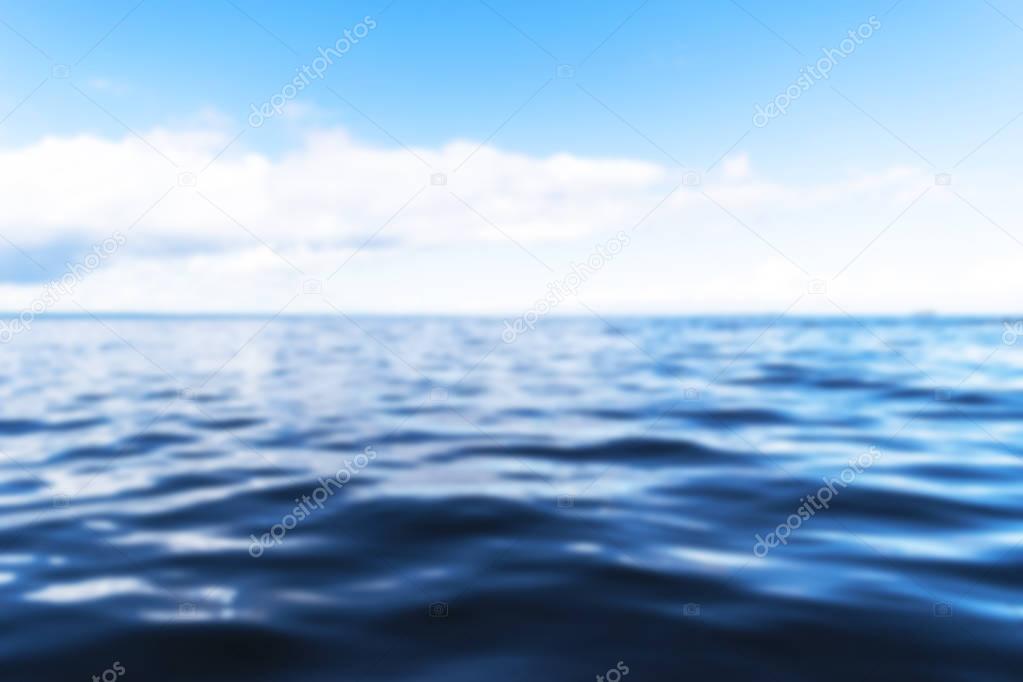 Blurred background with horizon line with summer sky and blur blue ocean