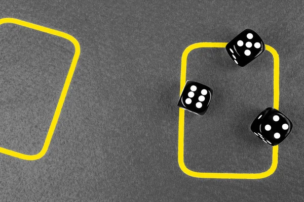 risk concept - playing dice on a green gaming table. Playing a game with dice. Red casino dice rolls. Rolling the dice concept for business risk, chance, good luck or gambling. Black and white