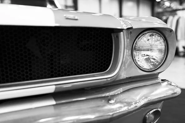 Front view of Classic retro Ford Mustang GT.Car exterior details. Headlight of a retro car. Black and white. — Stock Photo, Image