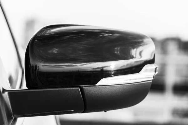 Left side Car mirror with reflection of beautiful colorful sky and sunset. Black and white. — Stock Photo, Image