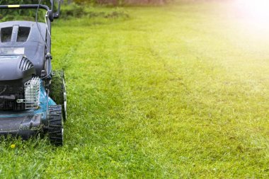 Çim biçme. Yeşil çimenlerin üzerinde çim biçme makinesi. biçme makinesi Çim ekipman. Bahçıvan bakım iş takım yakın görünümü güneşli gün biçme. Sotf ligthtning