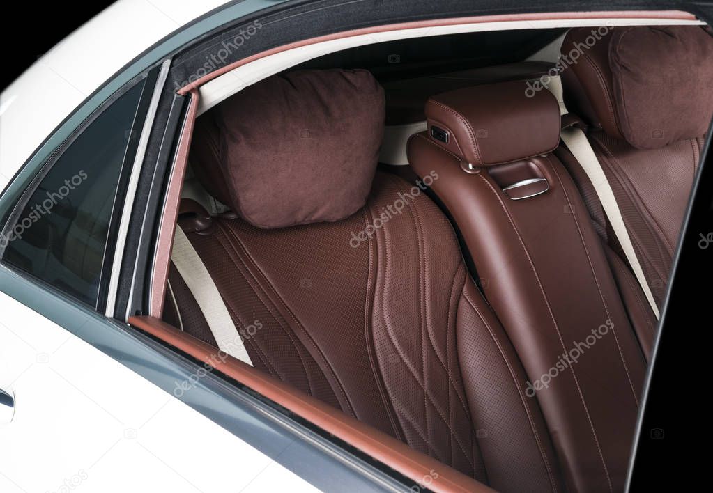 Modern Luxury car inside. Interior of prestige modern car. Comfortable leather seats. Red and white perforated leather. Back passenger seats.  Modern car interior details