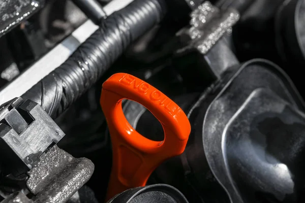 Bastoncino di olio rosso nel motore dell'auto. Misurazione del livello dell'olio motore. Indicatore del livello dell'olio del bastone con colore rosso per il controllo del livello dell'olio motore del sistema motore . — Foto Stock