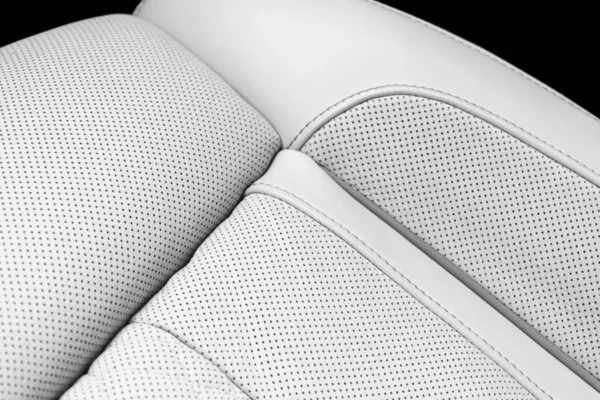 Modern luxury Car white leather interior. Part of perforated leather car seat details. White Perforated leather texture background. Texture, artificial leather with stitching. Perforated leather seats — Stock Photo, Image