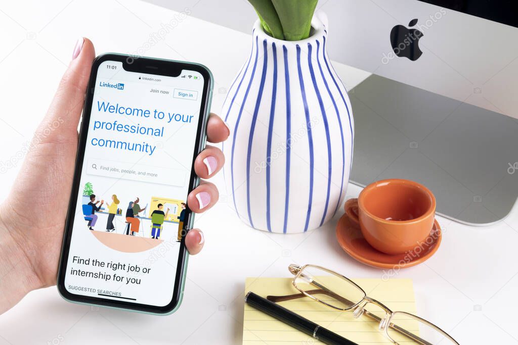 Helsinki, Finland, January 30, 2020: Linkedin homepage on Apple iPhone 11 screen close-up in woman hands. Linkedin app icon. linkedin.com. Social media app. Social network