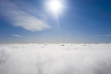 Mavi gökyüzünde hava manzaralı beyaz bulutlar. İnsansız hava aracı görüntüsü. Üst hava manzarası bulutlu. Bulutların dokusu. Yukarıdan bak. Bulutların üstünde gün doğumu ya da gün batımı. Panorama bulutları