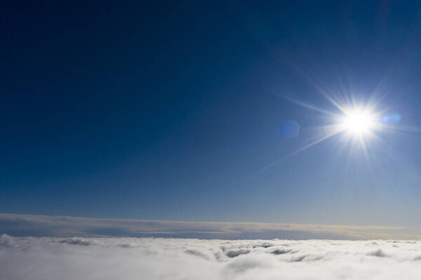 Aerial view White clouds in blue sky. View from drone. Aerial top view cloudscape. Texture of clouds. View from above. Sunrise or sunset over clouds. Panorama clouds