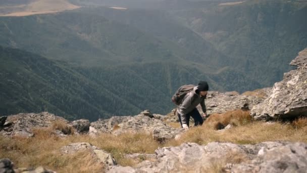 Caminhadas de jovens no topo de uma montanha — Vídeo de Stock