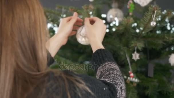 Close up of girl decorating Christmas tree — Stock Video