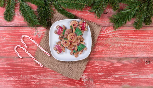Rustic red wooden boards with Christmas cookies and candy canes — Stock Photo, Image