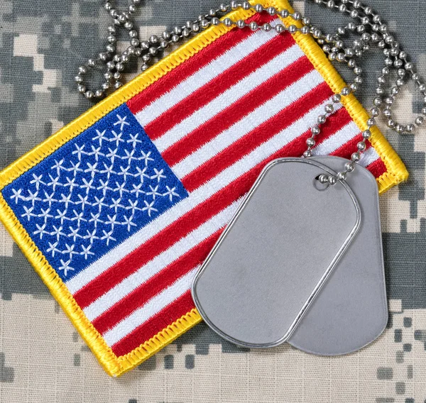 American flag with dog tags on camouflage