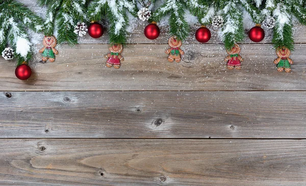 Top border of Christmas objects and snow on rustic wooden boards — Stock Photo, Image