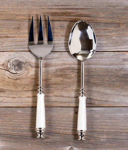 Large fork and spoon on rustic wood — Stock Photo, Image